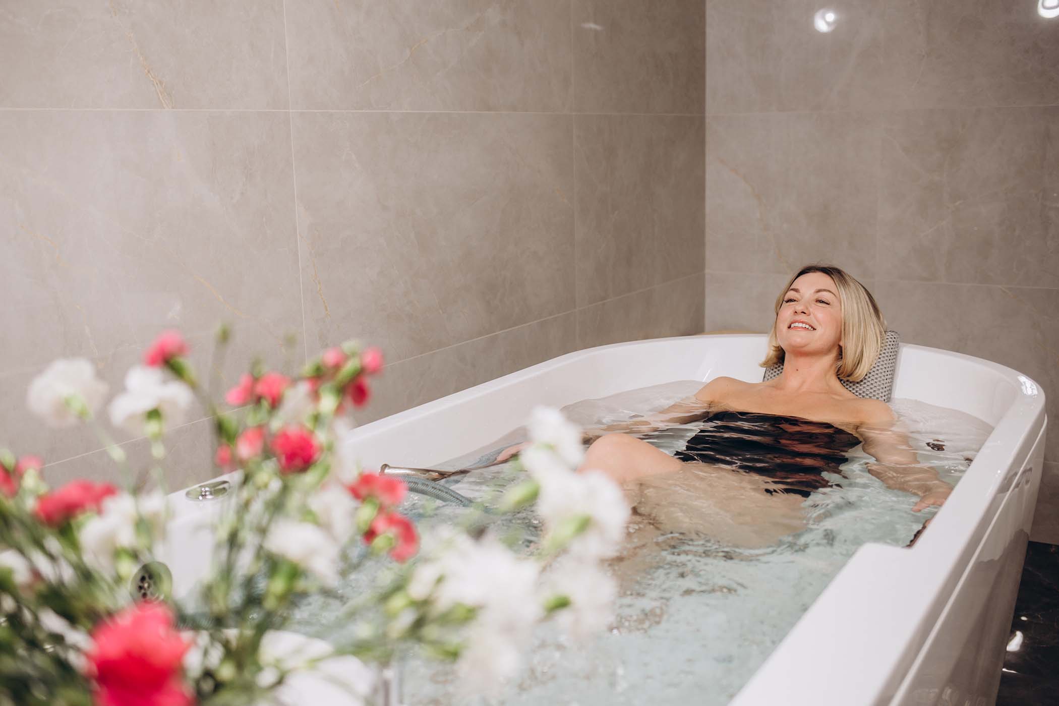 Woman in bathtub in spa setting